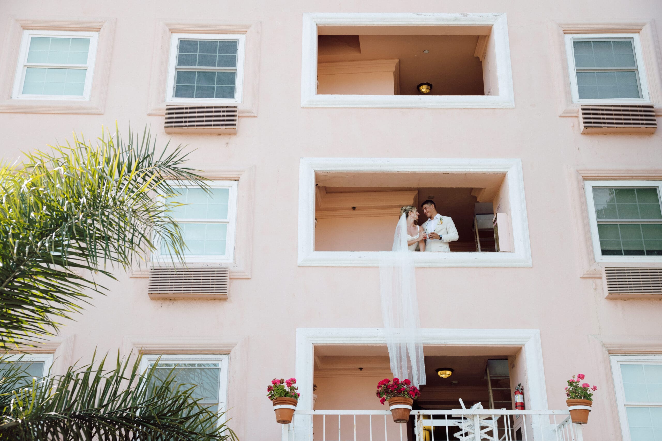 Grace & Rob at sunset on the cliffs of La Jolla—La Valencia wedding day magic Pink wedding cake moment at La Valencia, San Diego First dance in the Veranda Ballroom with ocean views Cake‑feeding guests under twinkling lights at Grace & Rob’s reception
